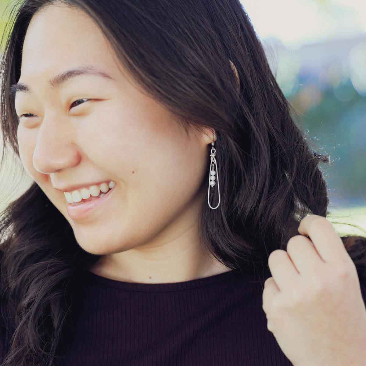 girl wearing a mother's love pearl sterling silver earrings