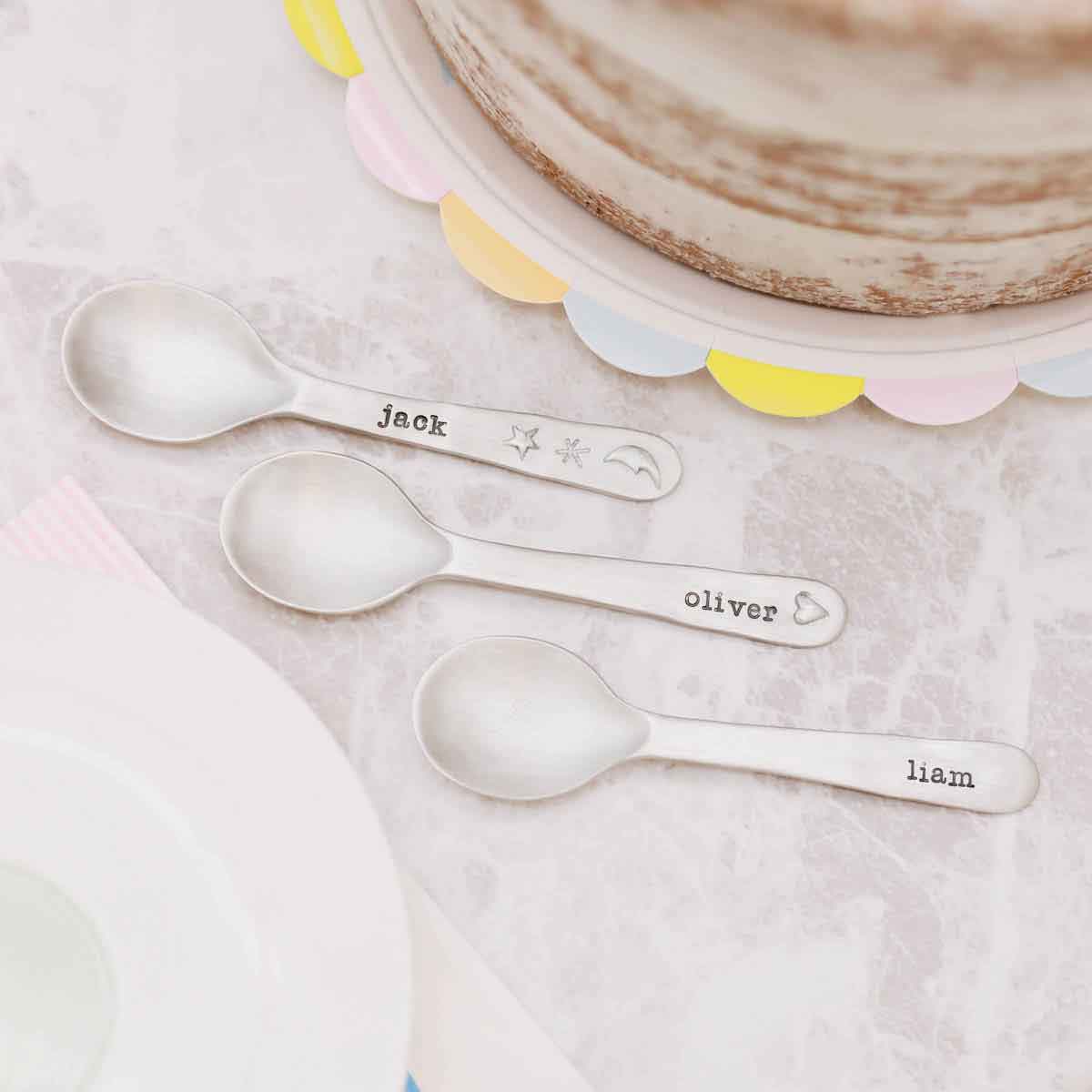 baby girl holding an Adorable Baby’s First Spoon