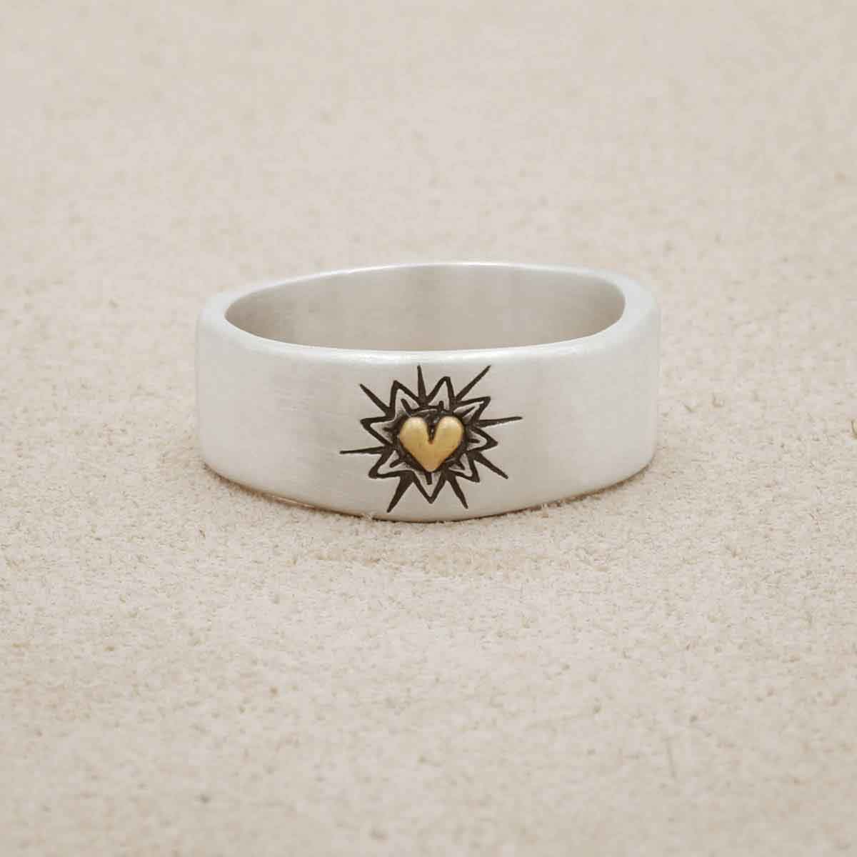 Bursting heart ring hand-molded sterling silver finished with a 10k yellow gold heart and hand-engraved with sunburst design