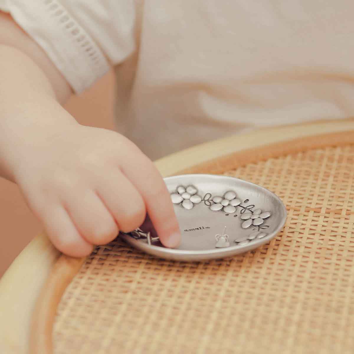 baby girl looking at a Daisy Chain Keepsake dish personalized with her name on it