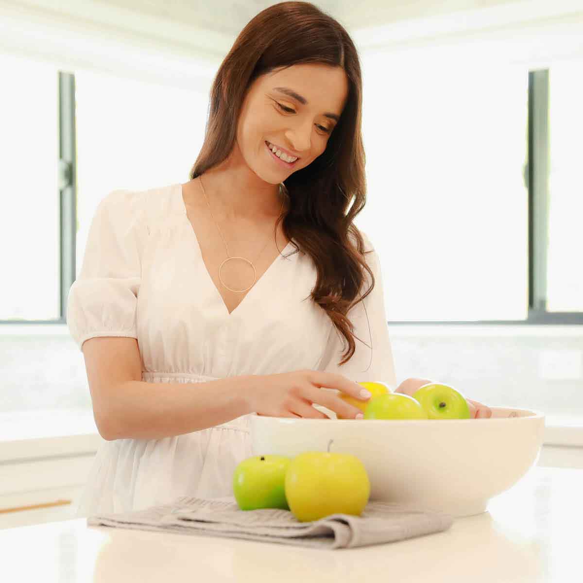 Woman holding a gold filled It All Matters Circle Necklace