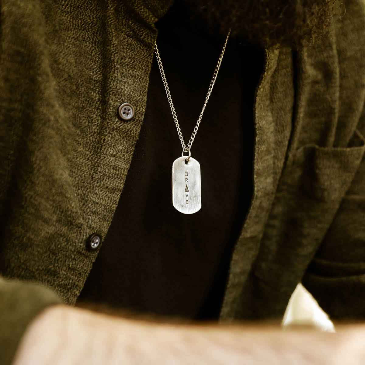 man wearing a Live Brave Dog Tag Necklace handcrafted in pewter