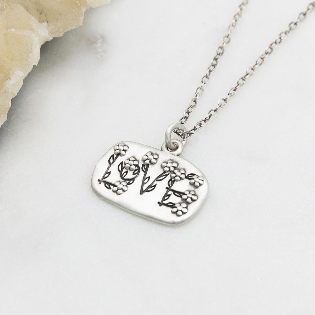 Love and Wildflowers necklace handcrafted in sterling silver including charm with a matte brushed finish