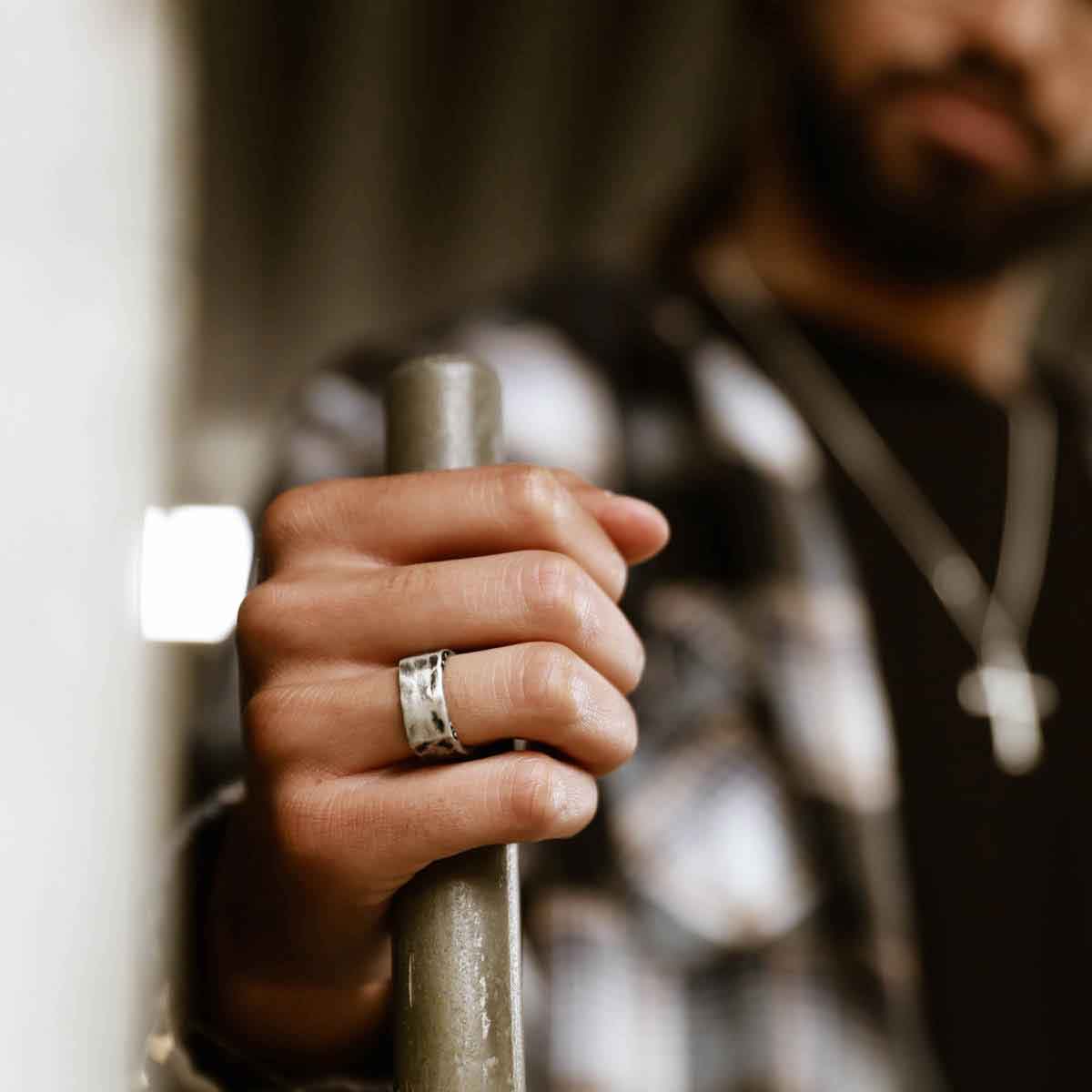 Man wearing Strong + True ring handcrafted in sterling silver and hammered to an antiqued finish and personalized with a meaningful name