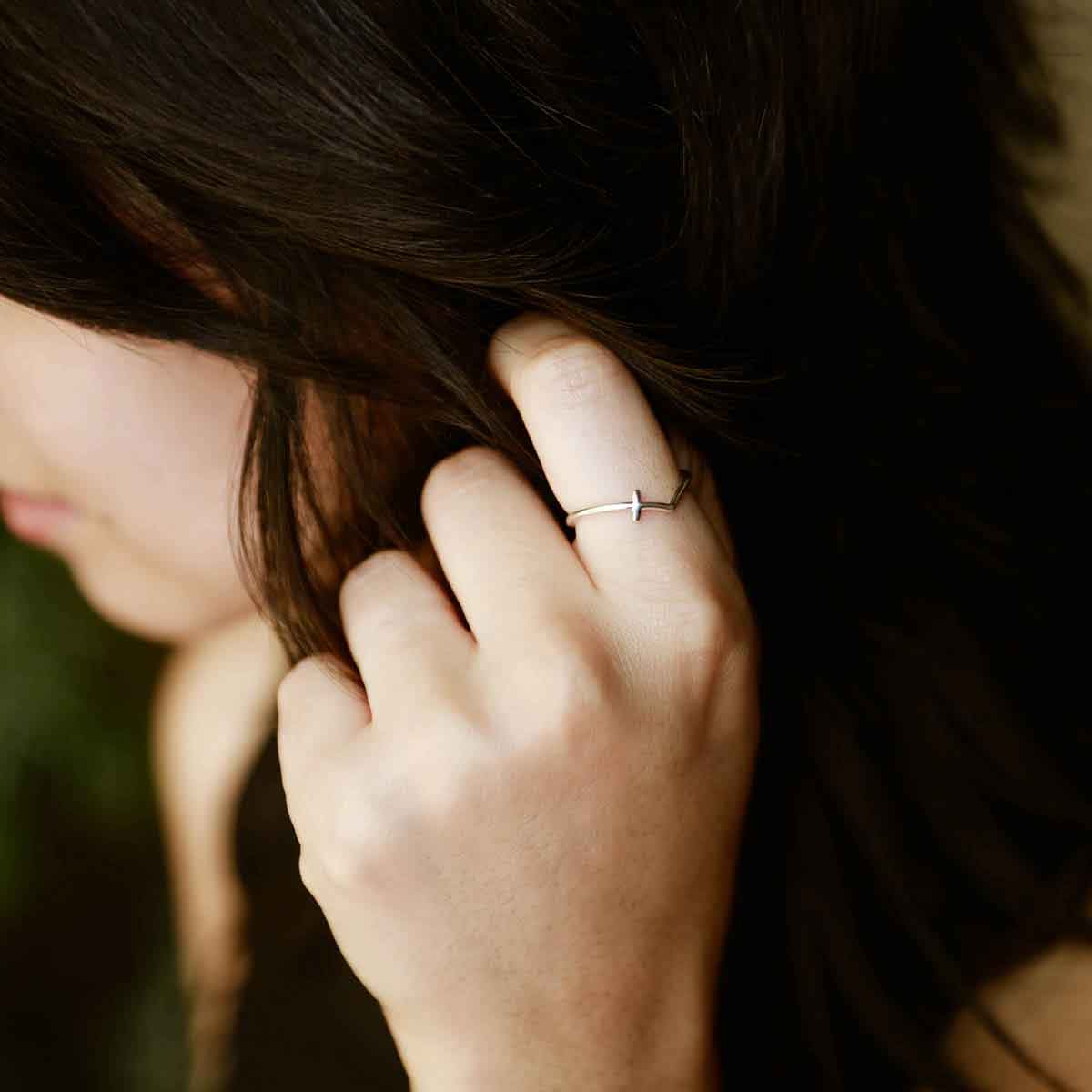woman holding a sterling silver At Every Turn Cross Ring