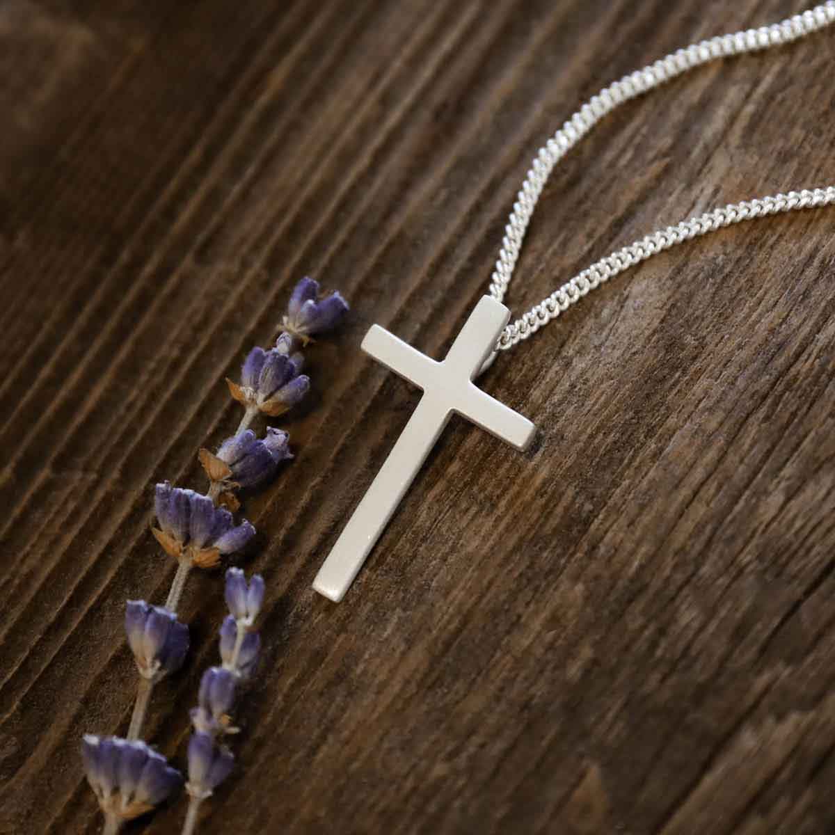 man wearing a sterling silver Beloved Cross necklace