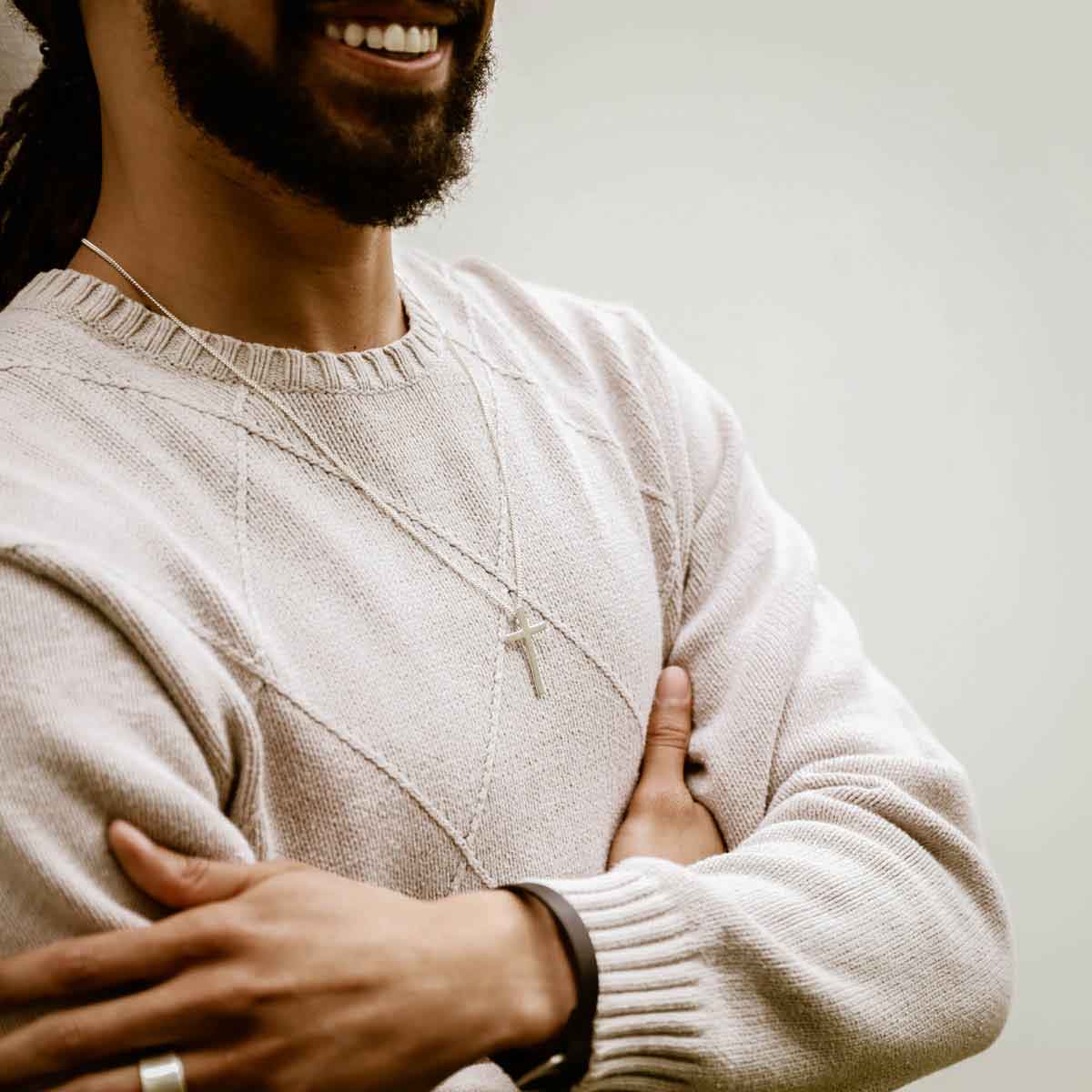 man wearing a sterling silver Beloved Cross necklace
