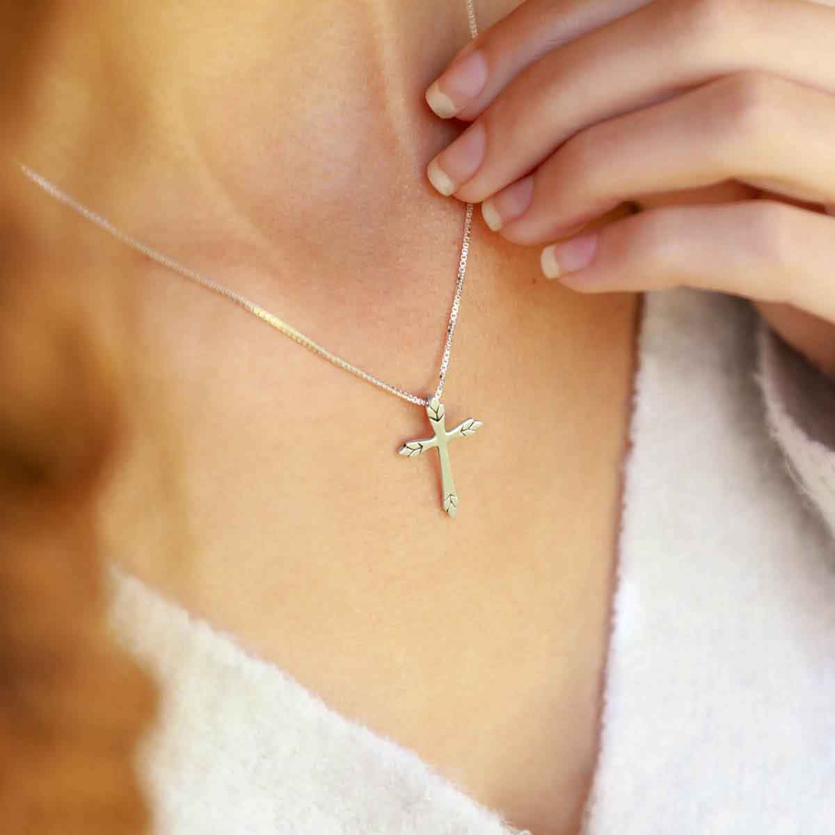 woman wearing a sterling silver Blooming Love Cross necklace