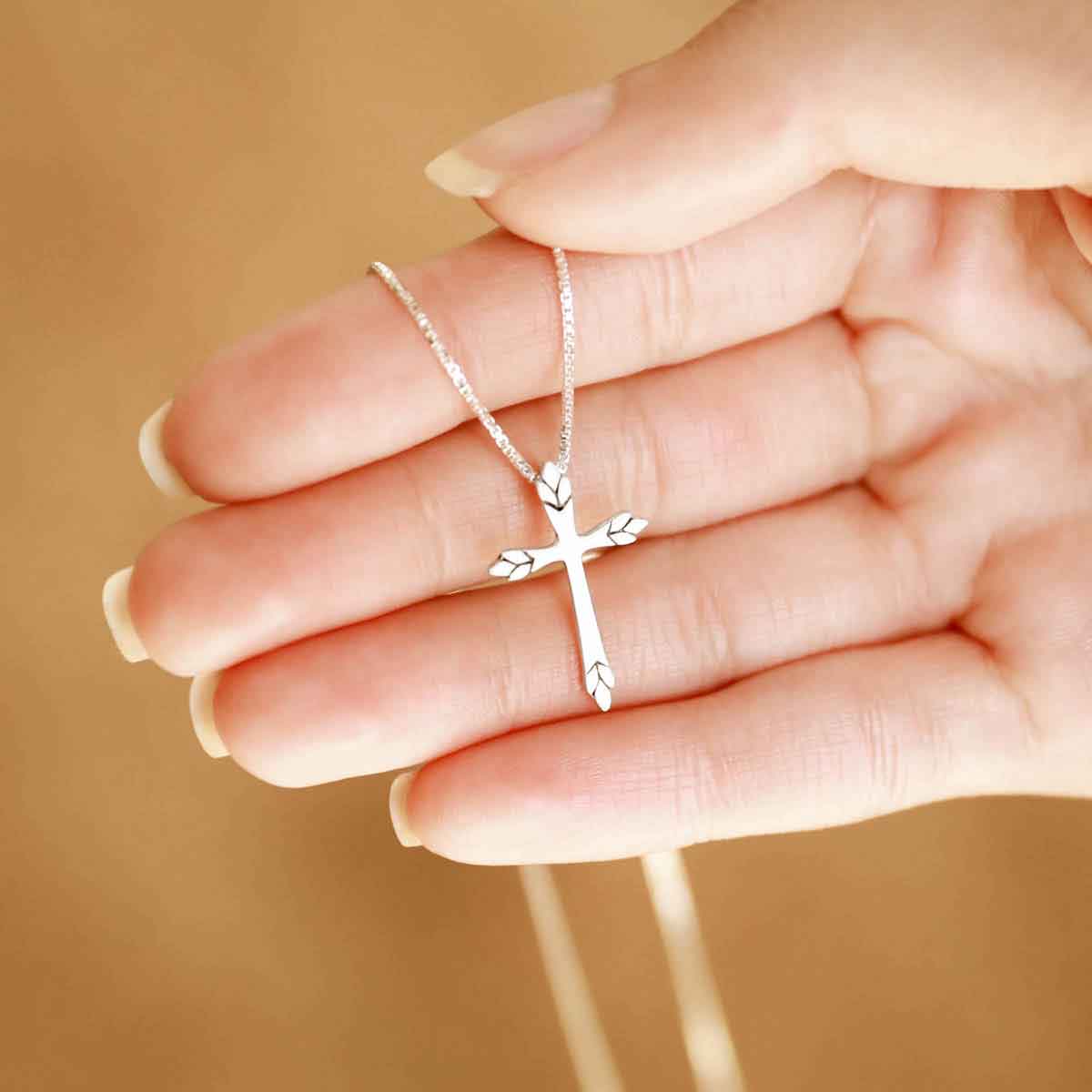 woman wearing a sterling silver Blooming Love Cross necklace