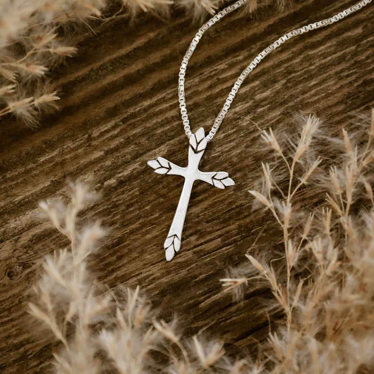 woman wearing a sterling silver Blooming Love Cross necklace
