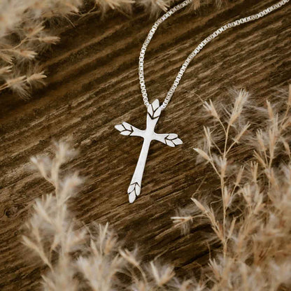 woman wearing a sterling silver Blooming Love Cross necklace