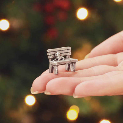 hand holding The Carolers Christmas Village Collection decorated with fake snow