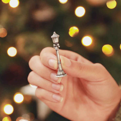 hand holding the bench with a puppy on it from The Carolers Christmas Village Collection