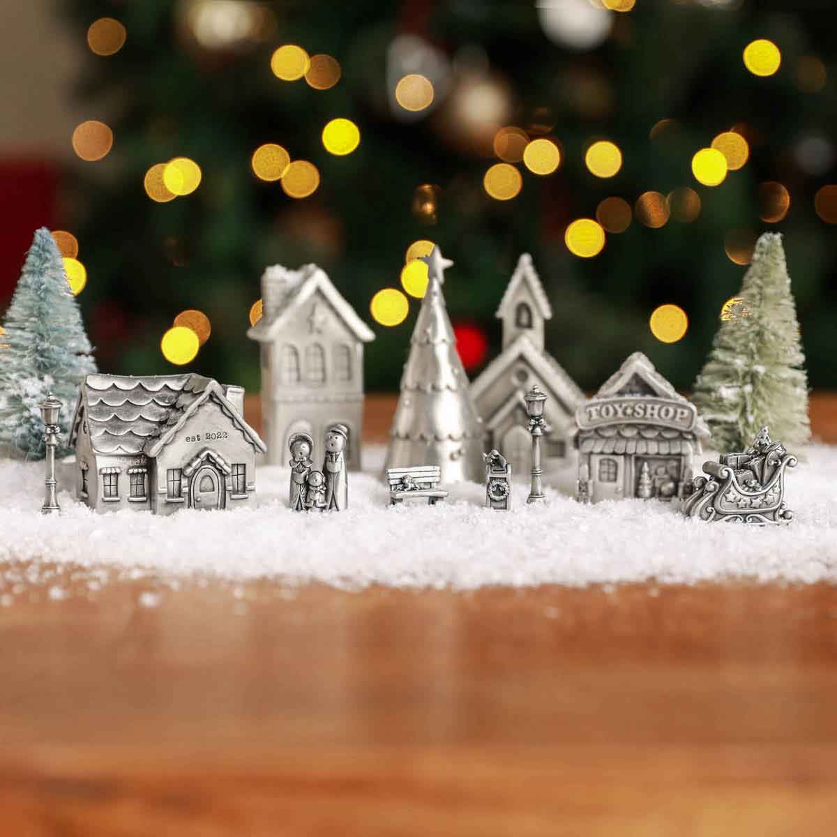 The Carolers Christmas Village Collection decorated with fake snow