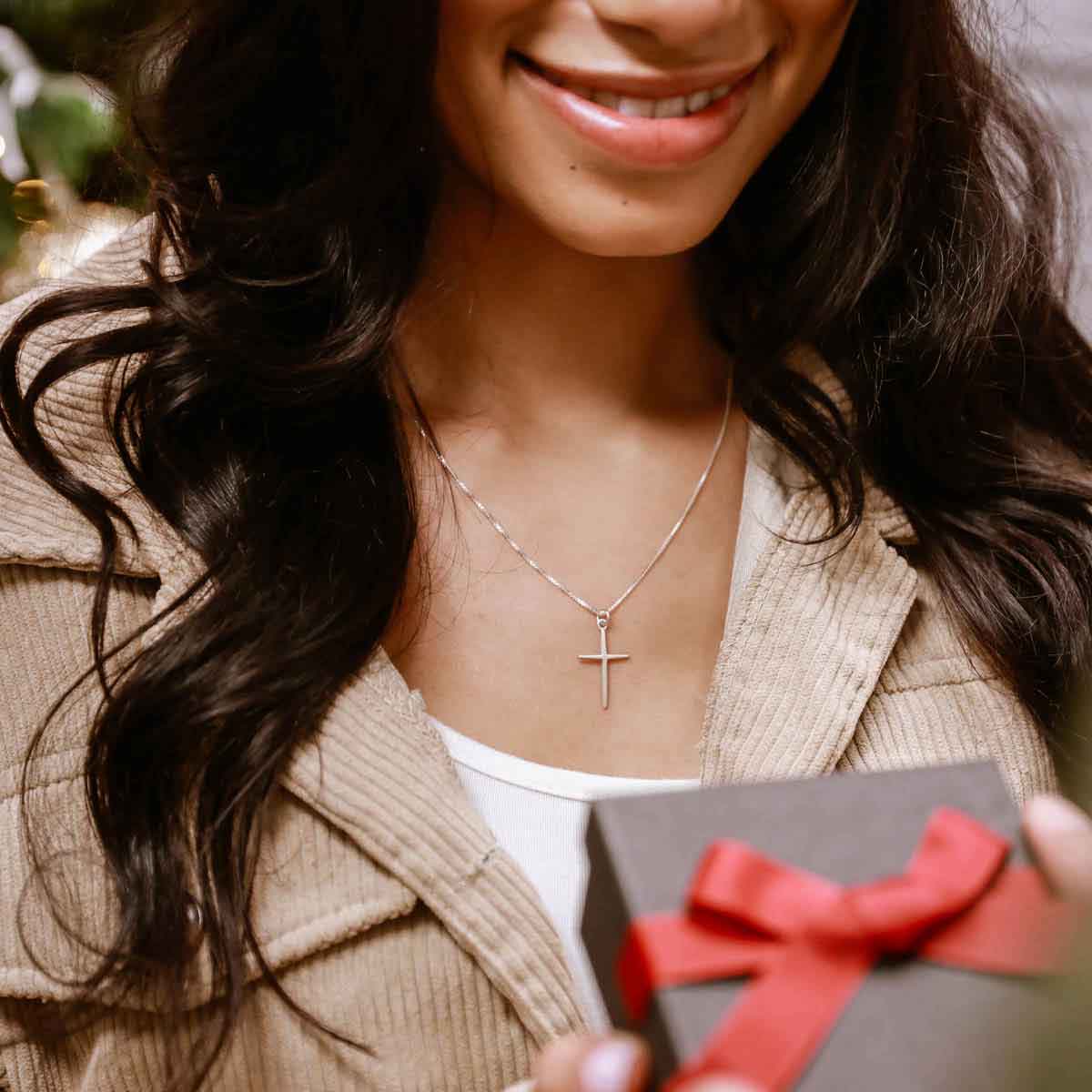 man gifts woman a sterling silver Covenant of Love Cross necklace