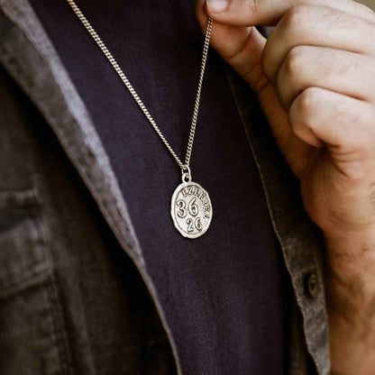 man wearing a Ezekiel 36:26 Coin Necklace