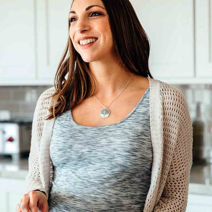 Girl wearing her Family tree necklace handcrafted in sterling silver with a matte brushed finish and personalized with a quote or family name