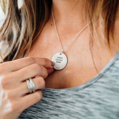 Girl wearing her Family tree necklace handcrafted in sterling silver with a matte brushed finish and personalized with a quote or family name