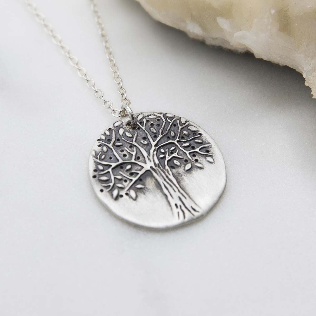 Family tree necklace handcrafted in sterling silver with a matte brushed finish and personalized with a quote or family name