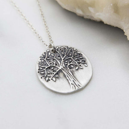 Family tree necklace handcrafted in sterling silver with a matte brushed finish and personalized with a quote or family name