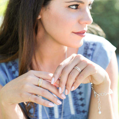 Girl wearing Geometric stacking ring handcrafted in yellow gold sterling silver and stackable with other mix and match stacking rings