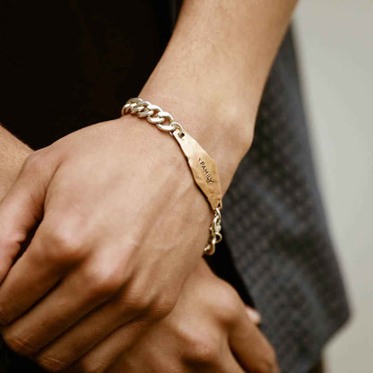 man wearing the Identity Bracelet with a personalized Bronze metal plate and Sterling Silver chain