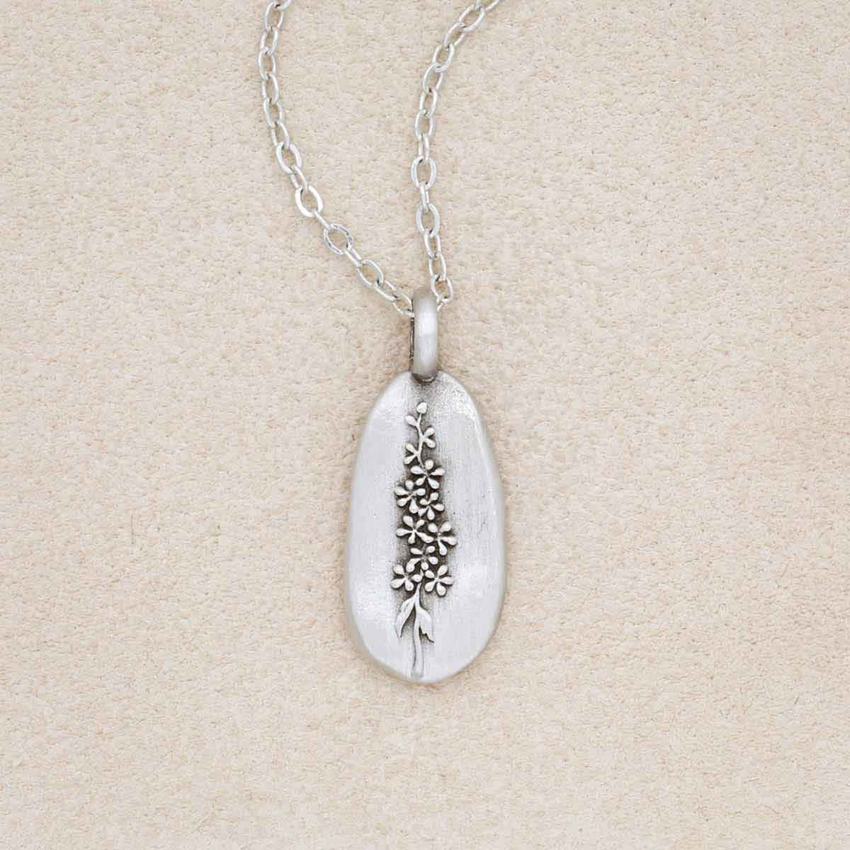 pewter July Birth Flower necklace with 18" link chain, on beige background