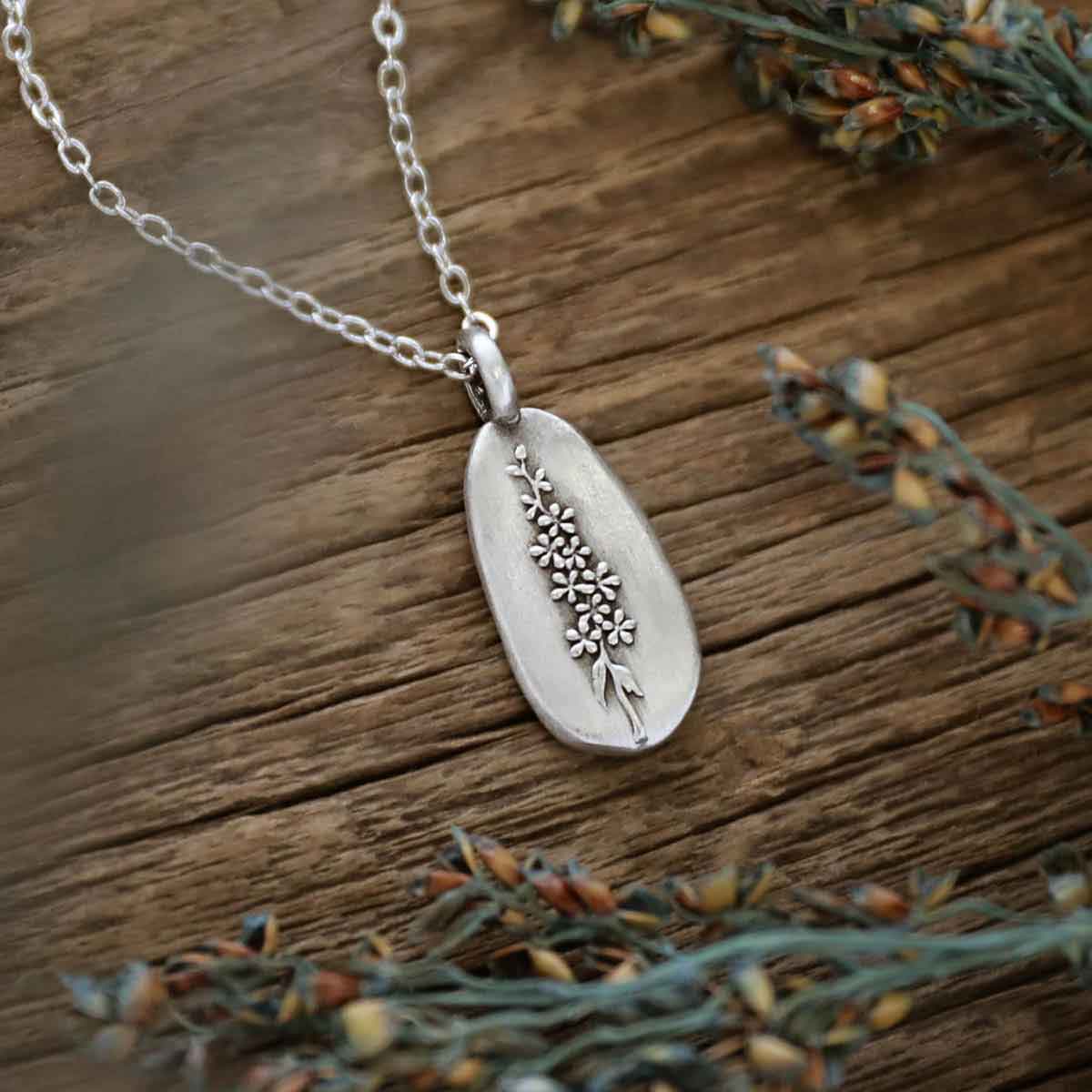 girl wearing a pewter July Birth Flower necklace with 18" link chain