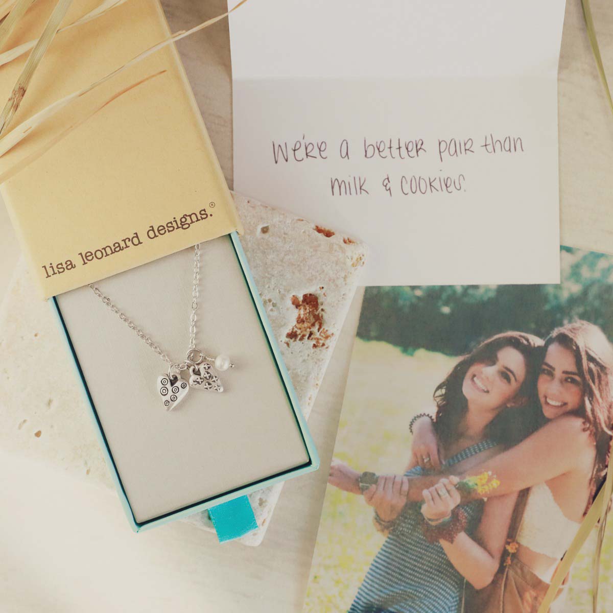 Light + Bright hearts necklace handcrafted in sterling silver with a matte brushed finish and the heart charm hung next to a vintage freshwater pearl in original packaging