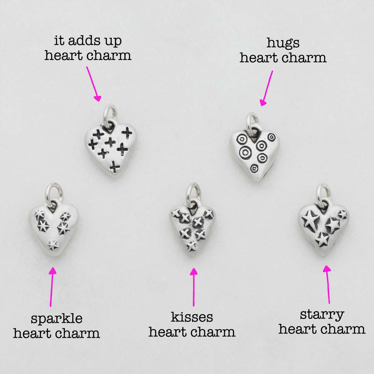 Light + Bright hearts charms handcrafted in sterling silver with a matte brushed finish and the heart charm hung next to a vintage freshwater pearl