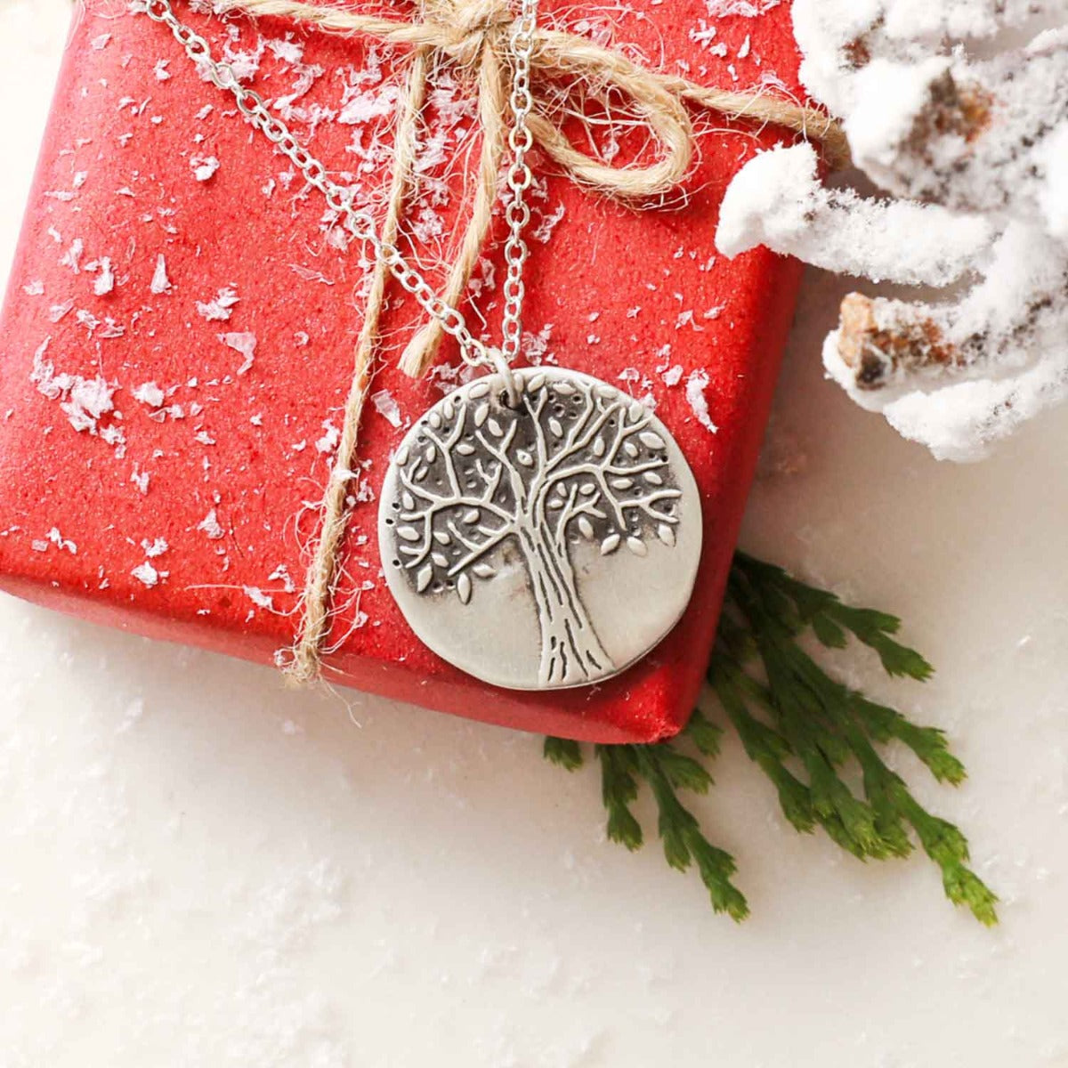Family tree necklace handcrafted in sterling silver with a matte brushed finish and personalized with a quote or family name
