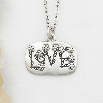 Love and Wildflowers necklace handcrafted in sterling silver including charm with a matte brushed finish