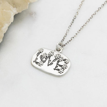 Love and Wildflowers necklace handcrafted in sterling silver including charm with a matte brushed finish
