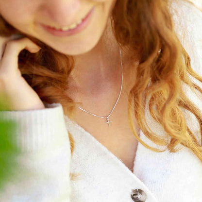 woman wearing a sterling silver Love & Accepted Cross necklace