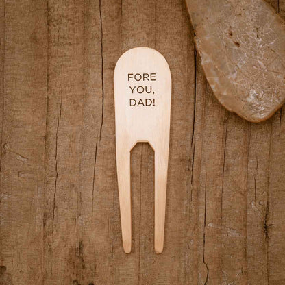 bronze personalized divot tool on wood background