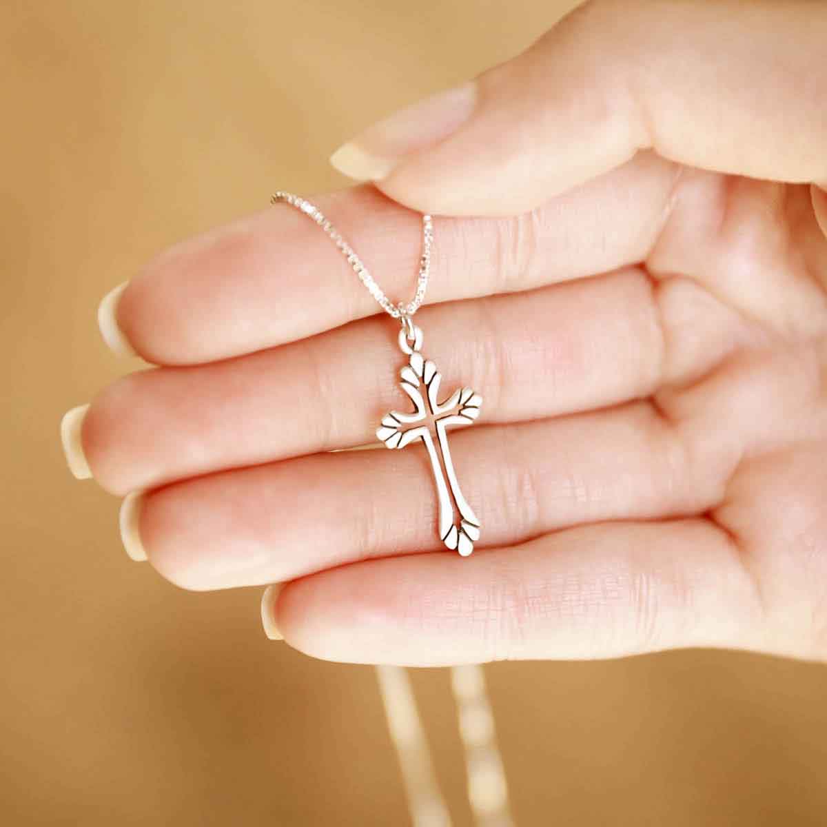 woman wearing a sterling silver Resurrection Cross Necklace