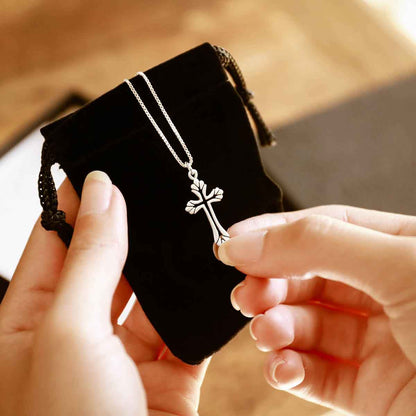 woman holding a sterling silver Resurrection Cross Necklace