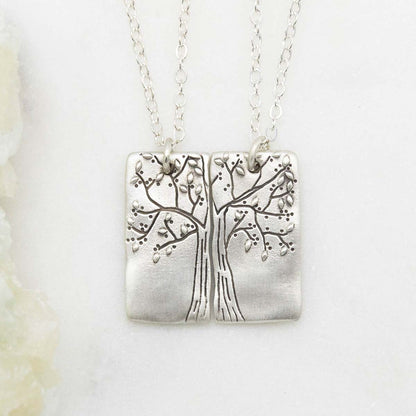 sterling silver rooted in love necklace set, on a white marble background