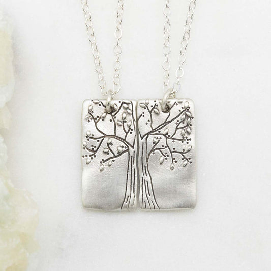 sterling silver rooted in love necklace set, on a white marble background