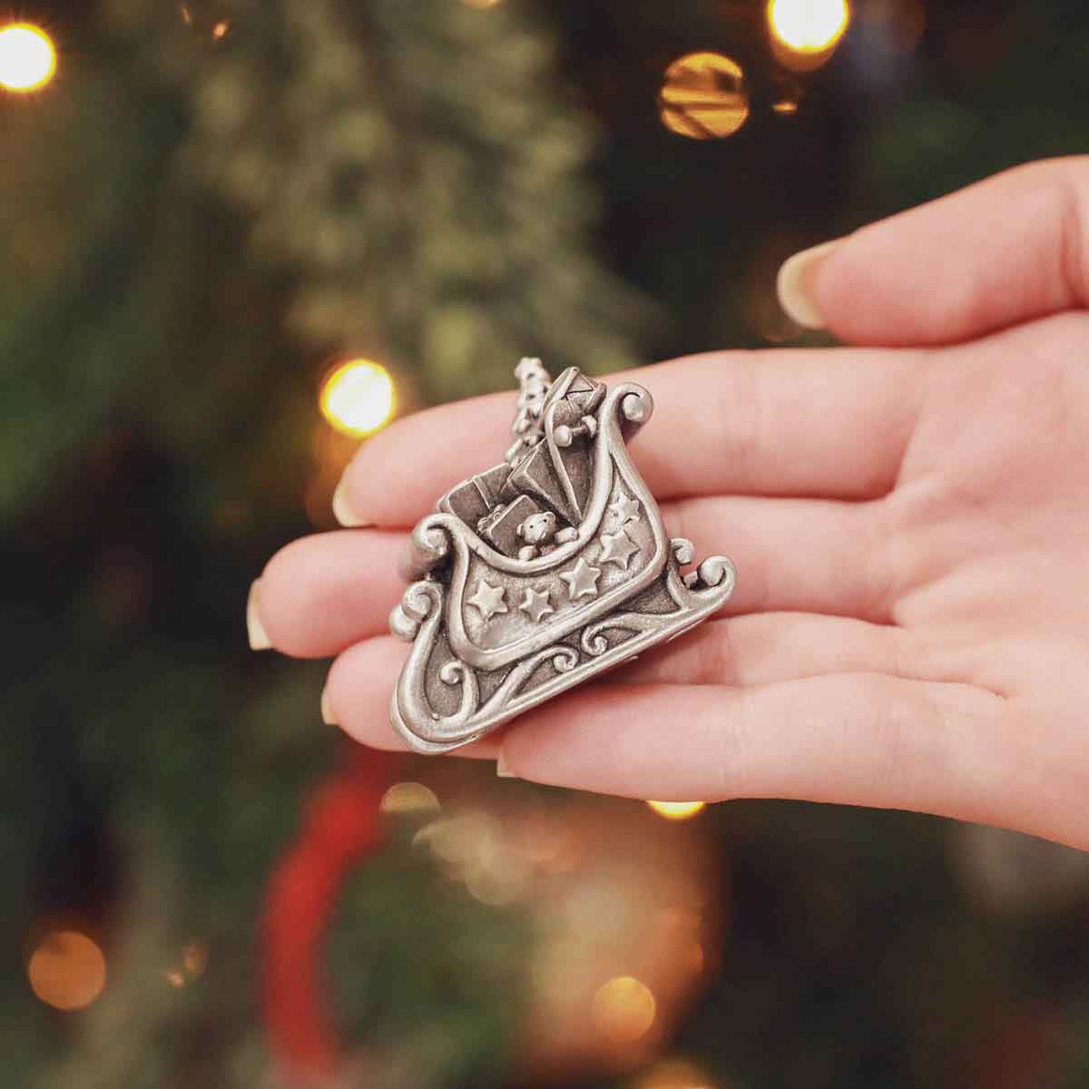 Hand holding the mailbox from the Santa’s Sleigh and Letters Christmas Village Collection