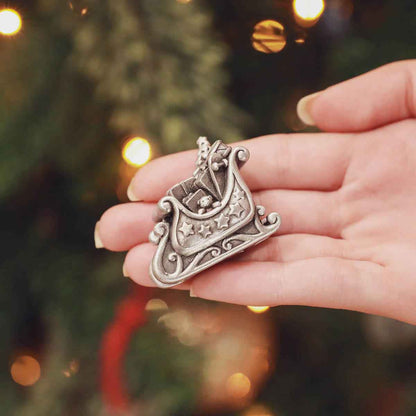 Hand holding the mailbox from the Santa’s Sleigh and Letters Christmas Village Collection