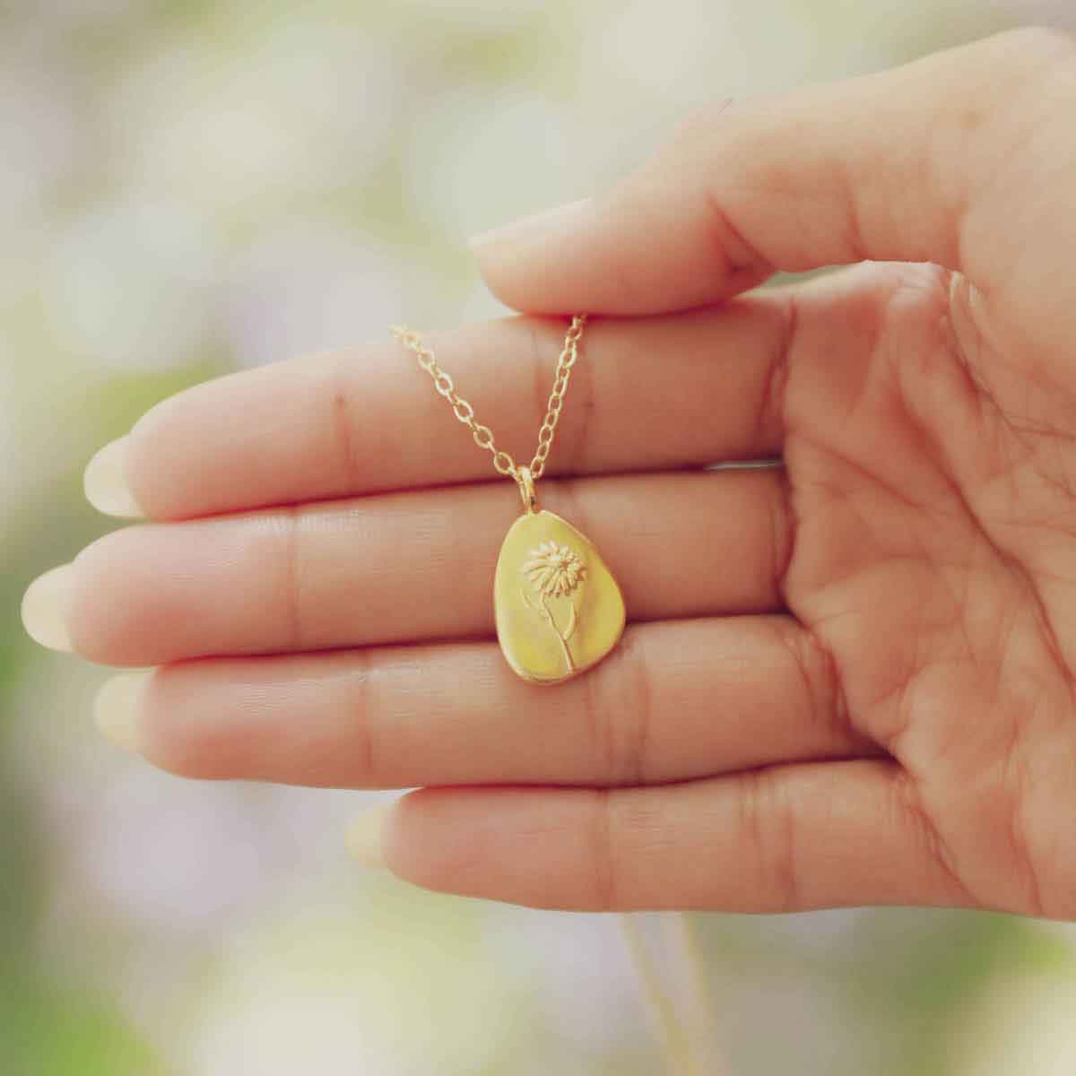 girl wearing a gold plated September birth flower necklace with an 18" gold filled link chain