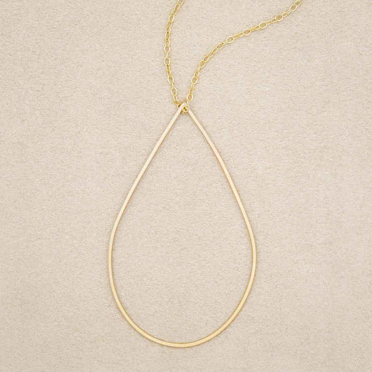 Sorrow and Joy Teardrop Necklace handcrafted in gold filled, on suede background