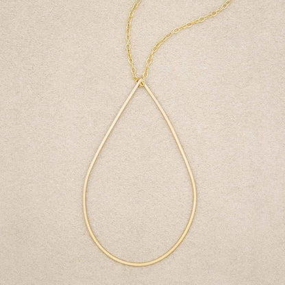 Sorrow and Joy Teardrop Necklace handcrafted in gold filled, on suede background
