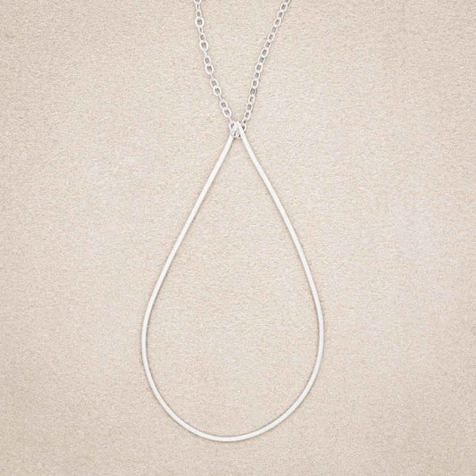 Sorrow and Joy Teardrop Necklace, handcrafted in sterling silver, on suede background
