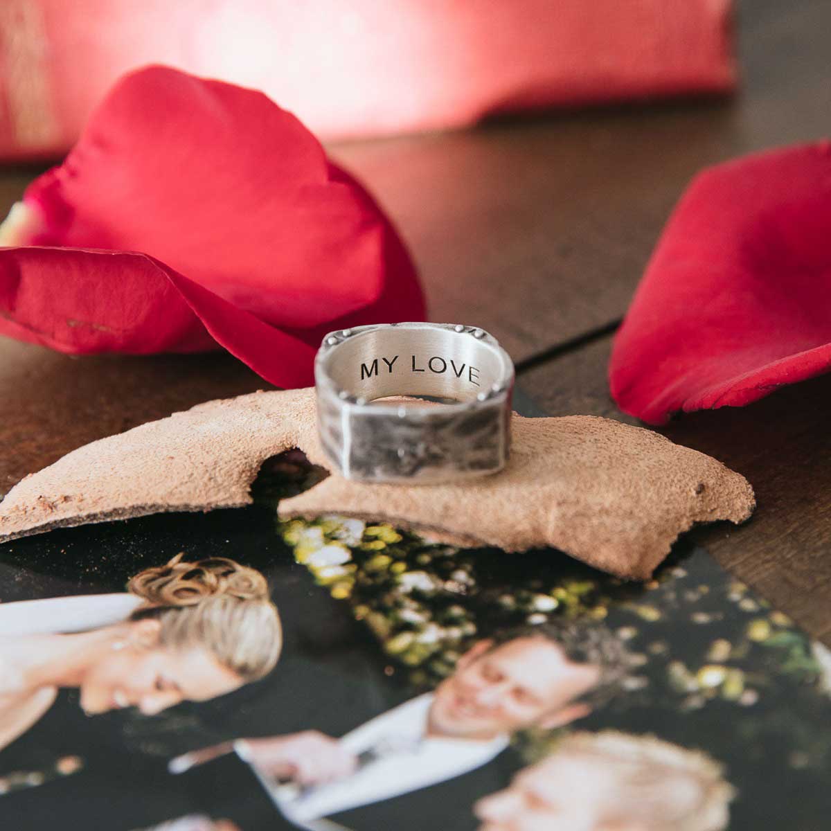 Man wearing Strong + True ring handcrafted in sterling silver and hammered to an antiqued finish and personalized with a meaningful name