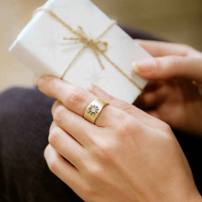 girl wearing her 14k yellow gold sunburst diamond ring with a 3mm conflict free diamond