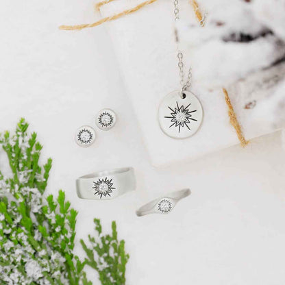 woman wearing pair of sterling silver sunburst stud earrings with a matte-brushed finish with 3mm crystals and her daughter