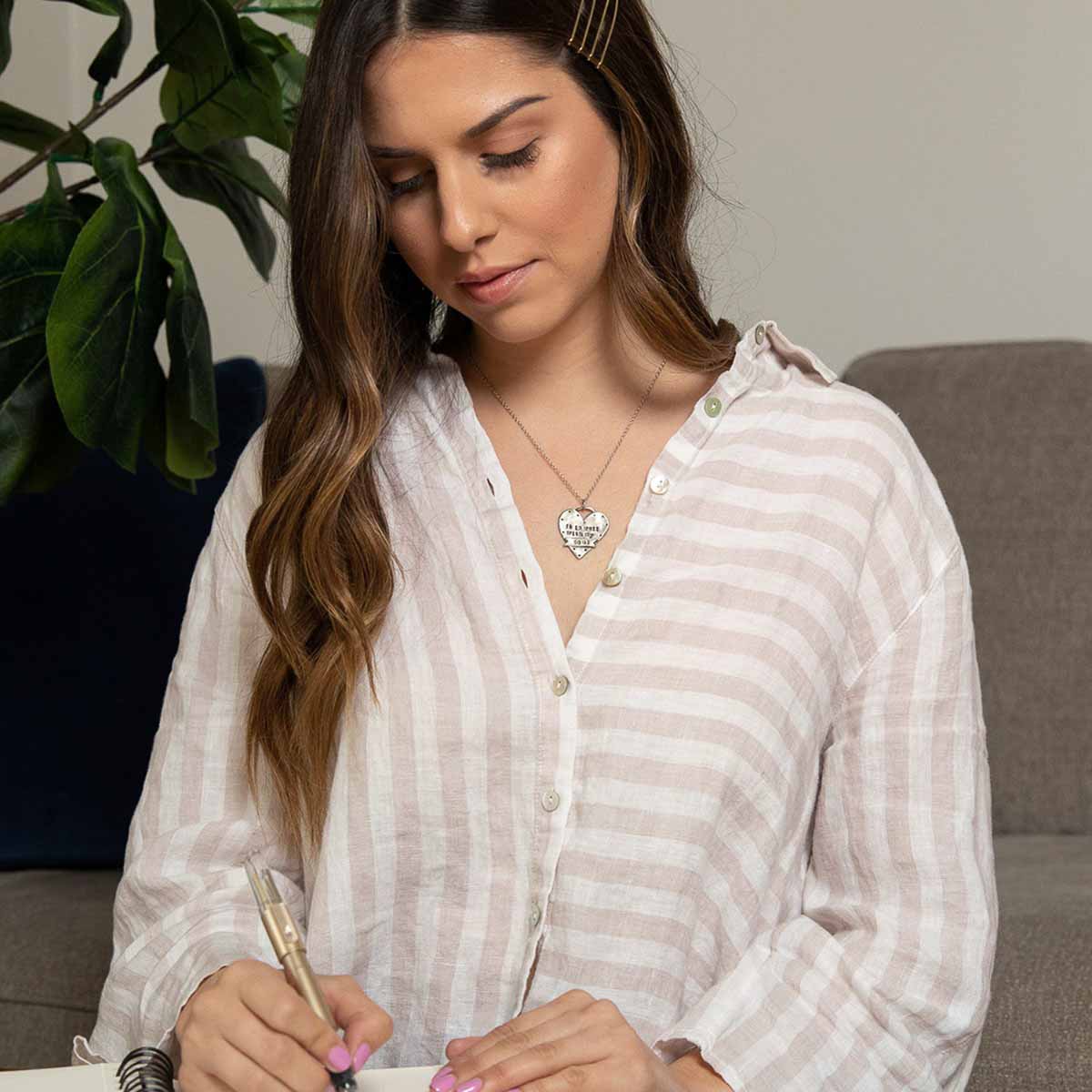 girl wearing well with my soul pewter necklace